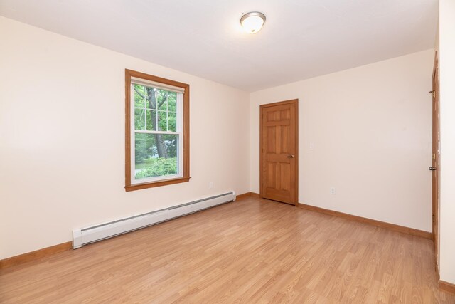 11 Penny Ln, Laconia, NH 03246 - spare room with baseboard heating and light wood-type flooring