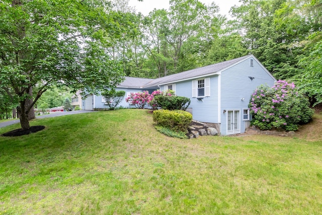 11 Penny Ln, Laconia, NH 03246 - view of front facade featuring a front lawn, a garage, and roof with shingles