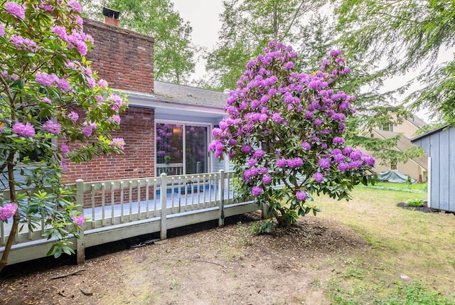 11 Penny Ln, Laconia, NH 03246 - rear view of house featuring a chimney, brick siding, and a deck