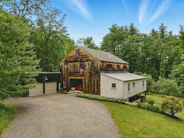 130A Amherst St, Amherst, NH 03031 - view of front of home featuring an outdoor structure, a front lawn, driveway, and a detached garage