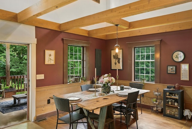 130A Amherst St, Amherst, NH 03031 - dining area featuring beam ceiling, wine cooler, healthy amount of natural light, and light wood-style flooring