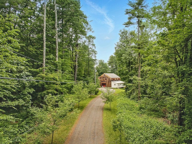 130A Amherst St, Amherst, NH 03031 - view of dirt / gravel road featuring a view of trees and a barn