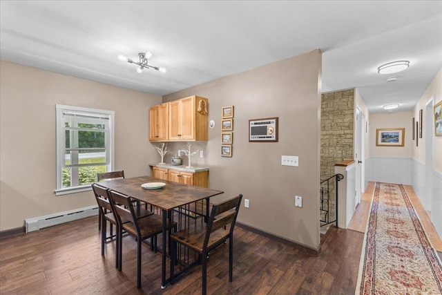 564 St Albans Rd, Swanton, VT 05488 - dining area featuring baseboard heating, dark wood finished floors, and a chandelier