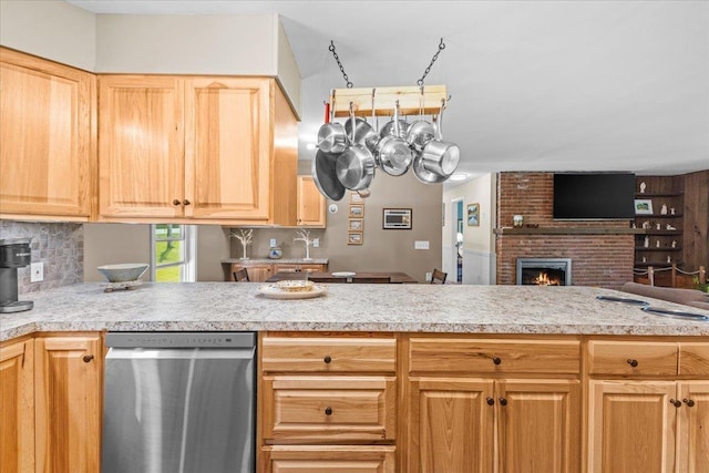 564 St Albans Rd, Swanton, VT 05488 - kitchen with stainless steel dishwasher, light countertops, open floor plan, and a fireplace