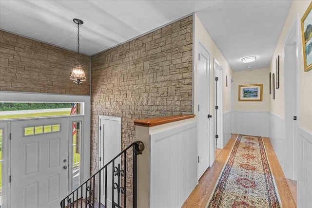 564 St Albans Rd, Swanton, VT 05488 - corridor featuring light wood-style floors, an upstairs landing, wainscoting, and healthy amount of natural light