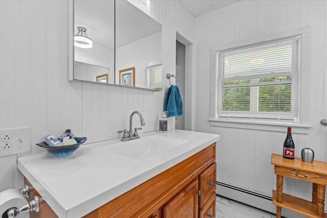 564 St Albans Rd, Swanton, VT 05488 - bathroom with baseboard heating, vanity, and marble look tile flooring