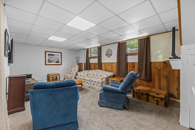 564 St Albans Rd, Swanton, VT 05488 - living room featuring wood walls, a paneled ceiling, and carpet