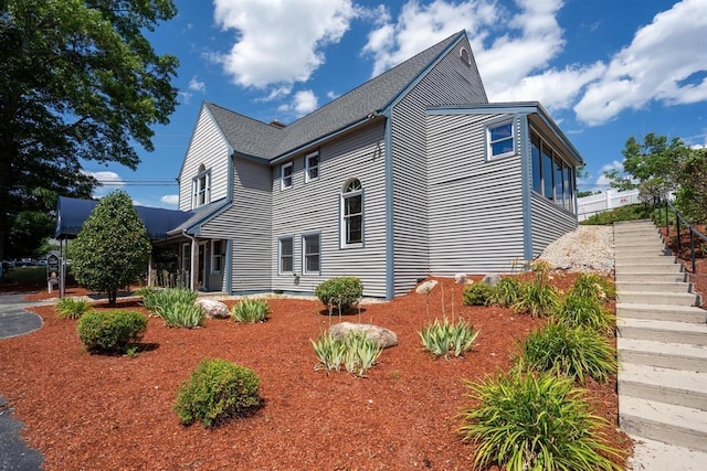 89 Eastern Ave Unit 306, Manchester, NH 03104 - view of property exterior featuring stairway and roof with shingles