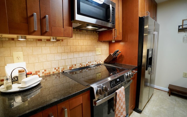89 Eastern Ave Unit 306, Manchester, NH 03104 - kitchen featuring appliances with stainless steel finishes, backsplash, brown cabinets, and light tile patterned flooring
