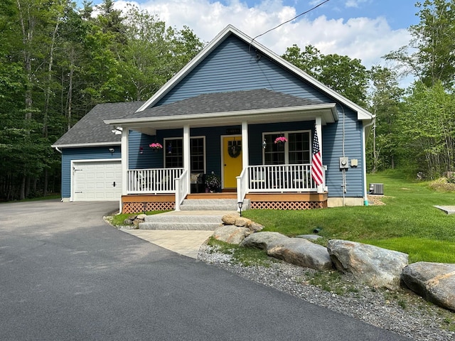326 Dublin Rd, Jaffrey, NH 03452 - view of front of home with a garage, roof with shingles, asphalt driveway, a porch, and a front lawn