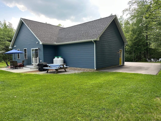 326 Dublin Rd, Jaffrey, NH 03452 - rear view of house with roof with shingles, a yard, and a patio