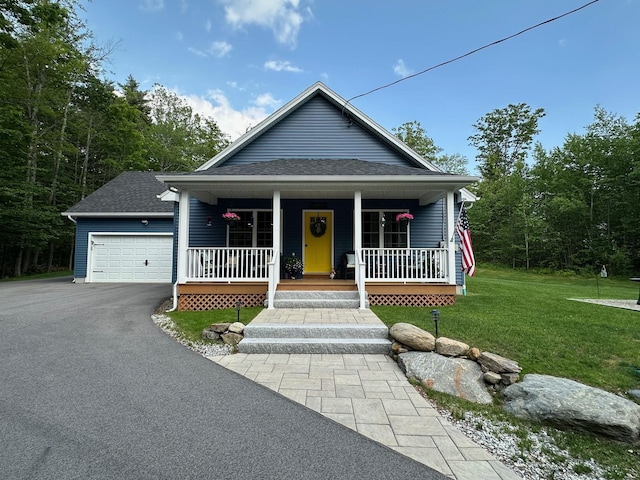 326 Dublin Rd, Jaffrey, NH 03452 - view of front of home with a front lawn, a porch, asphalt driveway, a shingled roof, and a garage
