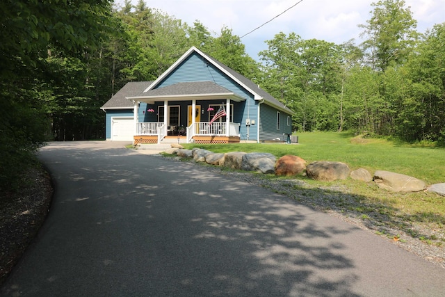 326 Dublin Rd, Jaffrey, NH 03452 - bungalow with covered porch, an attached garage, a front yard, asphalt driveway, and roof with shingles