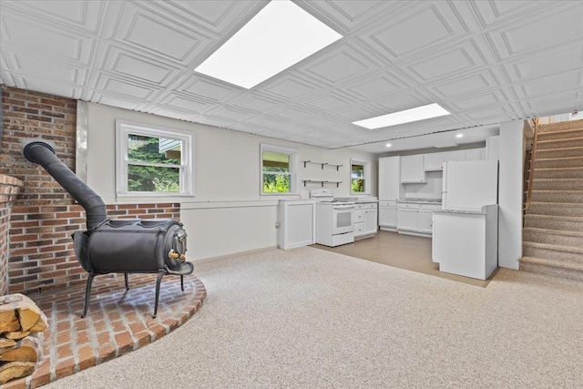 33 Winterlane Cir, Essex, VT 05452 - sitting room featuring stairway, a wood stove, light carpet, an ornate ceiling, and recessed lighting