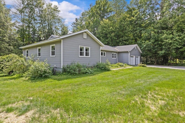 33 Winterlane Cir, Essex, VT 05452 - view of side of property featuring an attached garage, asphalt driveway, and a lawn