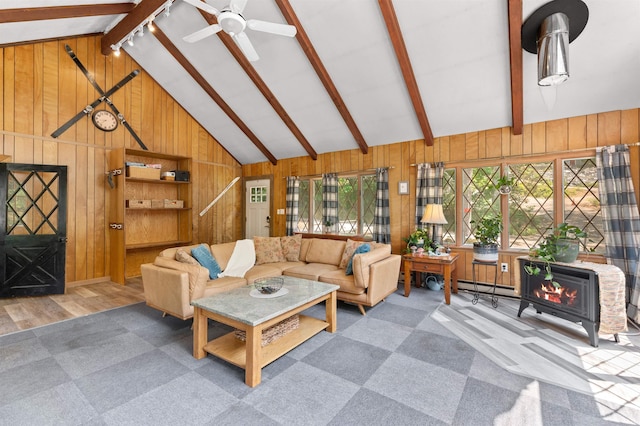 35 Alpstrausse Rd, Bartlett, NH 03845 - carpeted living area with wood walls, a ceiling fan, a wood stove, and wood finished floors