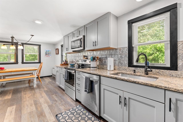 35 Alpstrausse Rd, Bartlett, NH 03845 - kitchen featuring stainless steel appliances, backsplash, wood finished floors, light stone countertops, and gray cabinetry