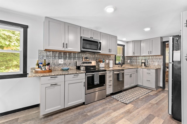 35 Alpstrausse Rd, Bartlett, NH 03845 - kitchen with appliances with stainless steel finishes, light wood-type flooring, decorative backsplash, light stone counters, and recessed lighting