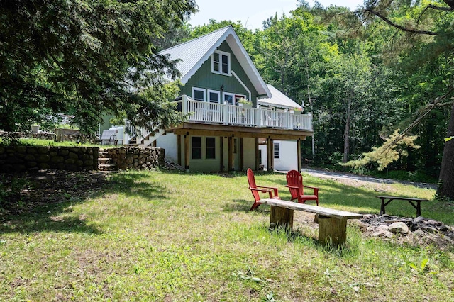 35 Alpstrausse Rd, Bartlett, NH 03845 - rear view of house with a deck, an outdoor fire pit, and a lawn