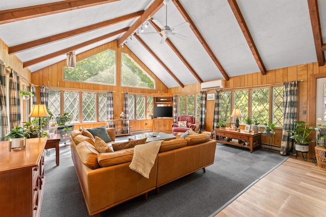 35 Alpstrausse Rd, Bartlett, NH 03845 - living room with a wall unit AC, healthy amount of natural light, wood walls, and a ceiling fan