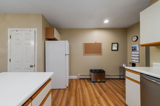 36 Circle Dr # 3, Ashland, NH 03217 - kitchen with freestanding refrigerator, stainless steel dishwasher, a baseboard heating unit, light countertops, and light wood-style floors