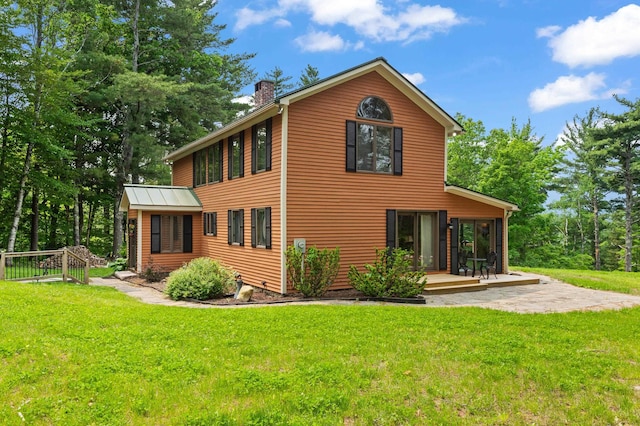 48 Merriman Forest Rd, Bartlett, NH 03812 - rear view of property with a chimney, a yard, and a patio