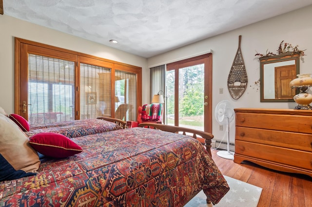 48 Merriman Forest Rd, Bartlett, NH 03812 - bedroom featuring access to outside, a baseboard radiator, hardwood / wood-style floors, and recessed lighting