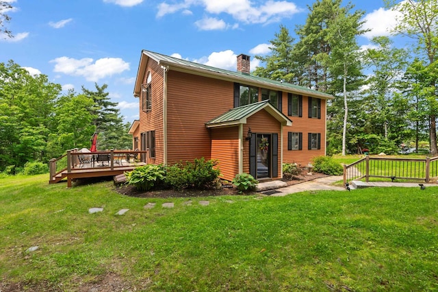48 Merriman Forest Rd, Bartlett, NH 03812 - view of front of house with a chimney, a wooden deck, a front lawn, and a metal roof