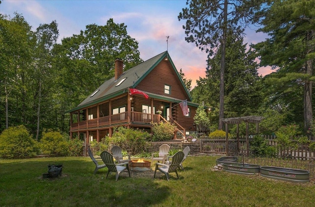59 Ossipee Mountain Rd, Ossipee, NH 03814 - rear view of property featuring a fire pit, log exterior, a yard, and a chimney
