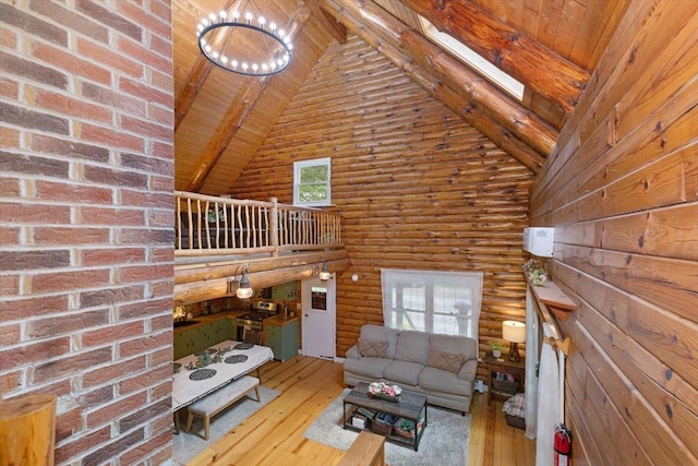 59 Ossipee Mountain Rd, Ossipee, NH 03814 - living area featuring high vaulted ceiling, wood-type flooring, log walls, a wooden ceiling with exposed beams, and a chandelier