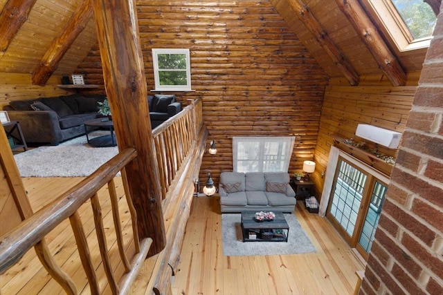 59 Ossipee Mountain Rd, Ossipee, NH 03814 - living area featuring a wood ceiling with exposed beams, hardwood / wood-style flooring, healthy amount of natural light, a skylight, and rustic walls