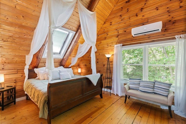 59 Ossipee Mountain Rd, Ossipee, NH 03814 - bedroom featuring a wall mounted AC, light wood finished floors, a skylight, and wooden walls