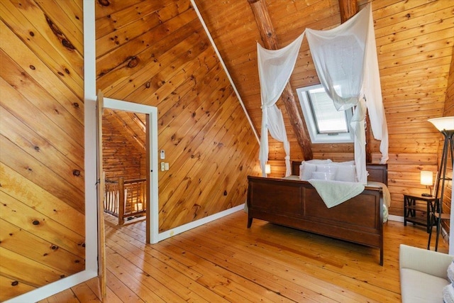 59 Ossipee Mountain Rd, Ossipee, NH 03814 - bedroom with light wood-style flooring, wood walls, and vaulted ceiling