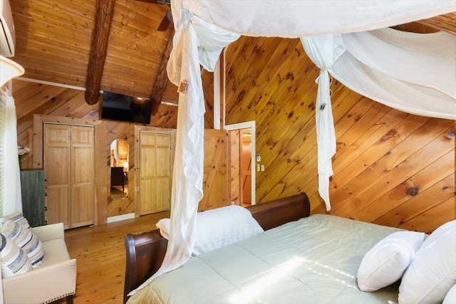 59 Ossipee Mountain Rd, Ossipee, NH 03814 - bedroom with wooden walls, hardwood / wood-style floors, a wood ceiling with exposed beams, an AC wall unit, and high vaulted ceiling