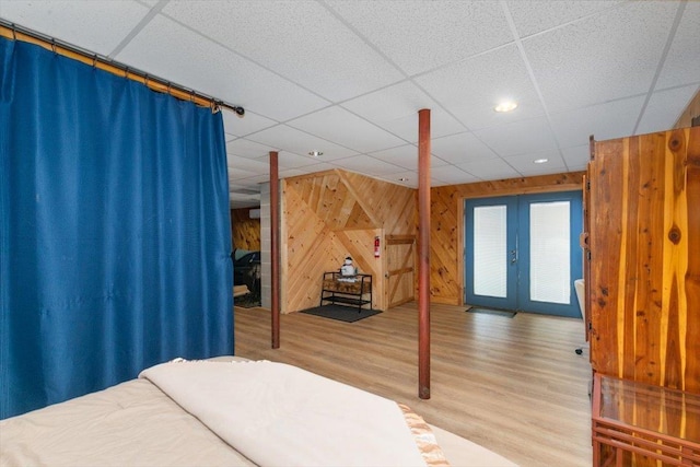 59 Ossipee Mountain Rd, Ossipee, NH 03814 - bedroom featuring wood walls, wood finished floors, a paneled ceiling, recessed lighting, and french doors