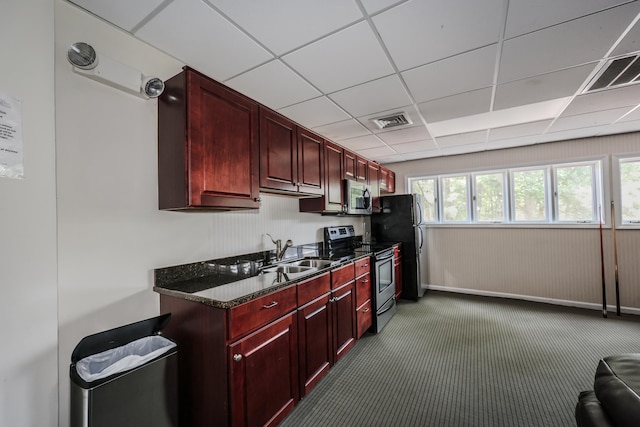 120 Fisherville Rd Unit 8, Concord, NH 03303 - kitchen featuring stainless steel appliances, reddish brown cabinets, a paneled ceiling, carpet flooring, and dark stone counters