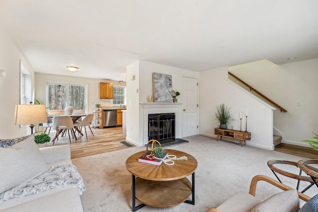9 Old Nashua Rd Unit B-1, Amherst, NH 03031 - living room featuring a fireplace with raised hearth, stairway, and light carpet