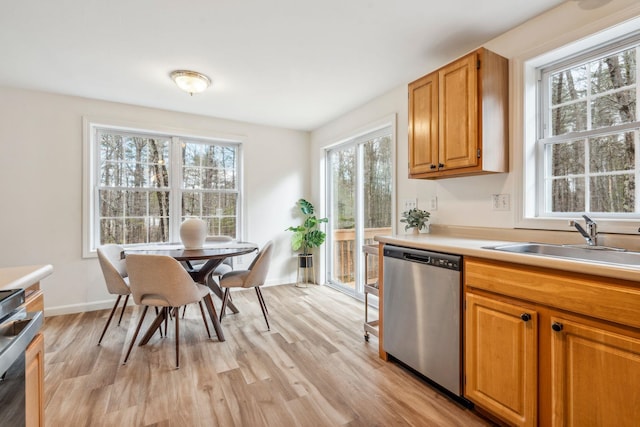 9 Old Nashua Rd Unit B-1, Amherst, NH 03031 - kitchen featuring dishwasher, light wood-style flooring, light countertops, stove, and brown cabinetry
