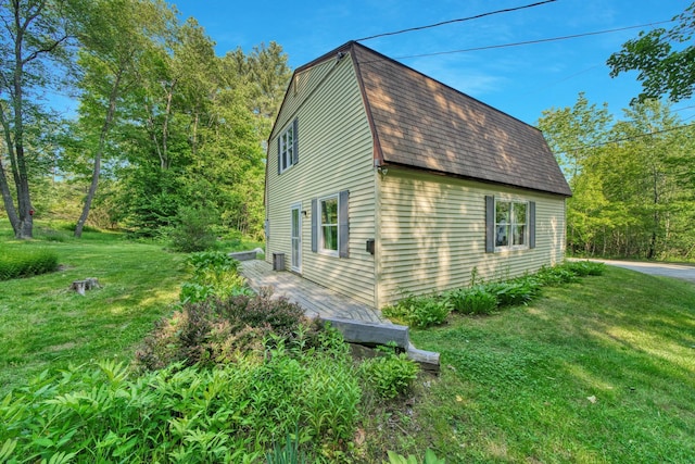 14 W Court Rd, Sunapee, NH 03782 - view of home's exterior with a gambrel roof, a shingled roof, and a yard