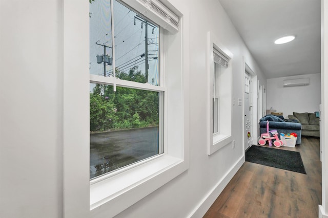 57 Central St, Farmington, NH 03835 - hall featuring an AC wall unit and dark wood finished floors