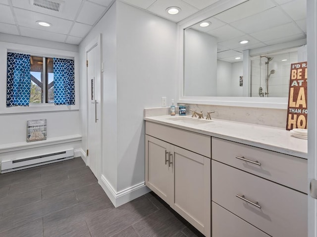 7 Reservoir Rd, Otis, MA 01253 - bathroom featuring a baseboard radiator, vanity, a shower with shower door, a drop ceiling, and recessed lighting