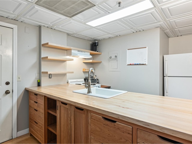 131 Main St Unit 308, Burlington, VT 05401 - kitchen featuring open shelves, freestanding refrigerator, brown cabinets, butcher block countertops, and a desk