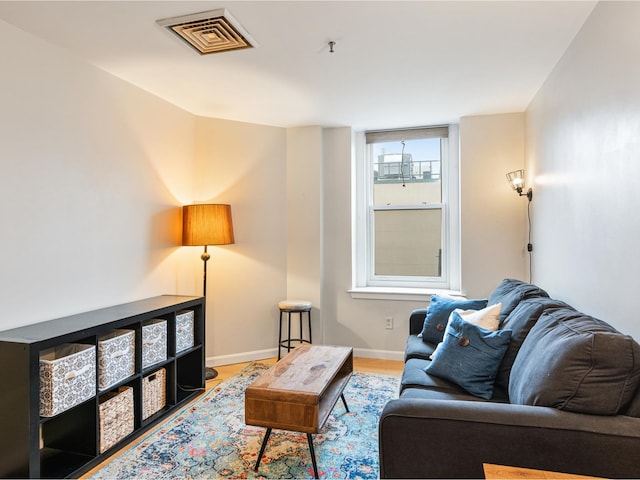 131 Main St Unit 308, Burlington, VT 05401 - living room featuring baseboards and wood finished floors