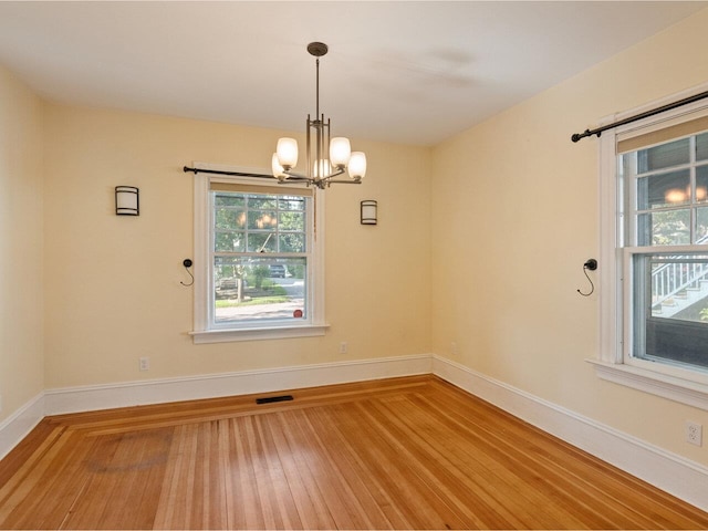 159 Loomis St, Burlington, VT 05401 - empty room featuring a chandelier and wood finished floors
