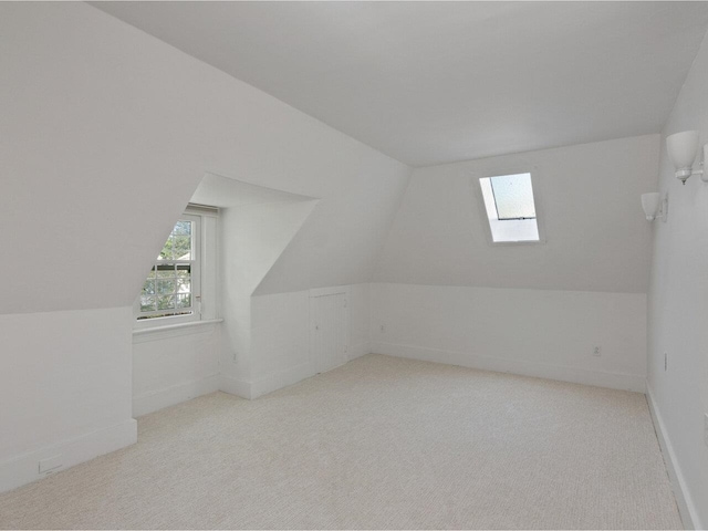 159 Loomis St, Burlington, VT 05401 - additional living space with a skylight, lofted ceiling, and carpet