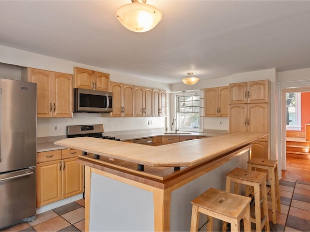 159 Loomis St, Burlington, VT 05401 - kitchen with stainless steel appliances, light brown cabinets, light countertops, and healthy amount of natural light