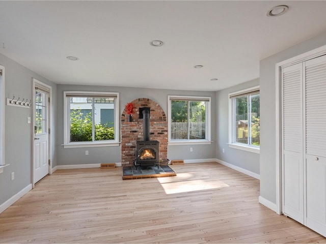 159 Loomis St, Burlington, VT 05401 - unfurnished living room with a wood stove, light wood-style floors, and recessed lighting