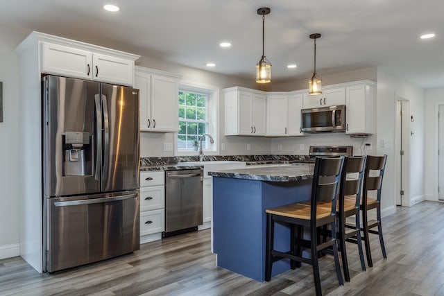 5 Turnpike St, Pembroke, NH 03275 - kitchen featuring appliances with stainless steel finishes, white cabinets, wood finished floors, and recessed lighting
