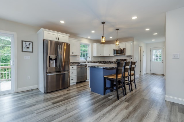 5 Turnpike St, Pembroke, NH 03275 - kitchen featuring appliances with stainless steel finishes, white cabinets, recessed lighting, a center island, and light wood finished floors