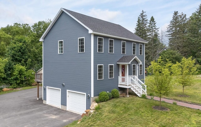 5 Turnpike St, Pembroke, NH 03275 - view of front of house with a front lawn, asphalt driveway, a garage, and a shingled roof